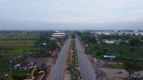 Aerial view of a road lined with trucks parked on the side of the road in a.. Stock Footage 297458528