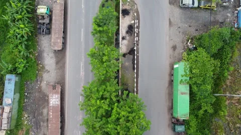 Aerial view of a road lined with trucks parked on the side of the road in a.. Stock Footage 297459237