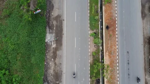 Aerial view of a road lined with trucks parked on the side of the road in a.. Stock Footage 297459382
