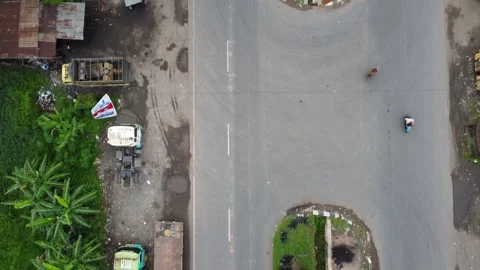 Aerial view of a road lined with trucks parked on the side of the road in a.. Stock Footage 297463388