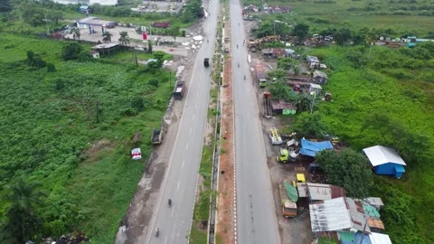Aerial view of a road lined with trucks parked on the side of the road in a.. Stock Footage 297464066