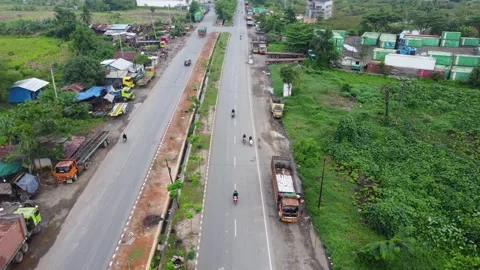 Aerial view of a road lined with trucks parked on the side of the road in a.. Stock Footage 297464146