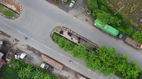 Aerial view of a road lined with trucks parked on the side of the road in a.. Stock Footage 297464407