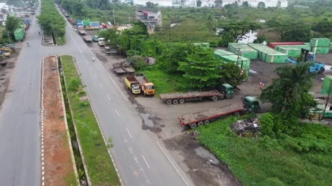 Aerial view of a road lined with trucks parked on the side of the road in a.. Stock Footage 297464894