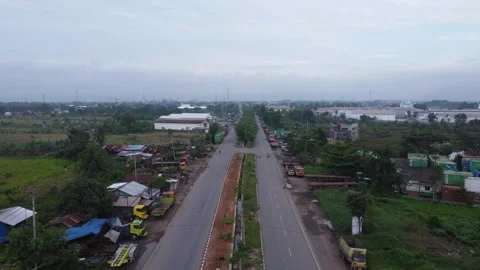Aerial view of a road lined with trucks parked on the side of the road in a.. Stock Footage 297464928