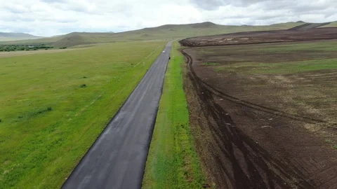 Aerial view of road in the middle of the field, Khakassia, Siberia, Russia. Stock Footage 314697656