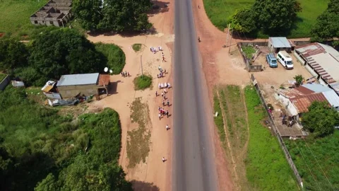 Aerial view of a road passing through a rural area with houses and trees Stock Footage 318223794