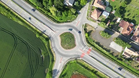 Aerial view of road roundabout intersection with moving traffic Stock Footage 316594899