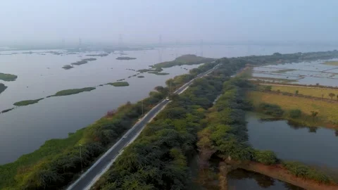 Aerial View Road On side of huge Lake Stock Footage 164786917