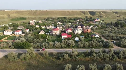 Aerial view of a road in a small town. A dump truck moves along the road. Stock Footage 164453424