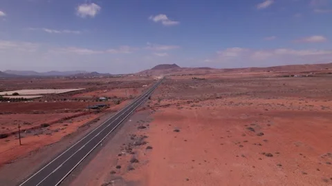Aerial View of Road Through Arid Volcanic Terrain in Fuerteventura Stock Footage 309018255