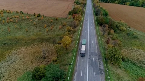 Aerial view of the road through fall forest Stock Footage 81396948