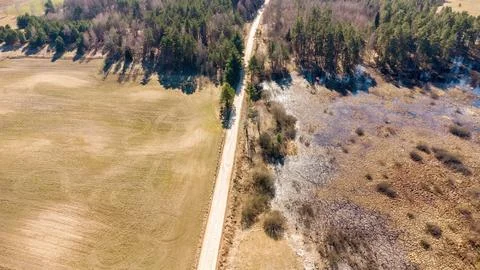 Aerial view of the road through fields and swamp Stock Photos