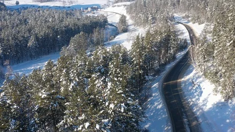 Aerial view road through the forest under the snow Stock Footage 122680989