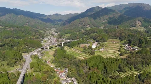 Aerial View of a Road Through Mountain Landscapes Stock Footage 336956237