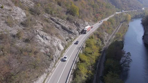 Aerial view on road traffic and river in rocky mountains cliff Stock Footage 48846498