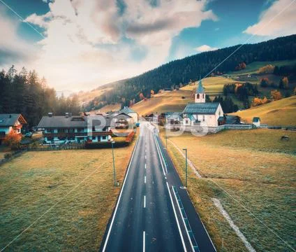 Aerial view of the road in the village in mountains at sunset Stock Photos