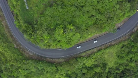 Aerial view of a road winding through the andes with cars passing by Stock Footage 143676516