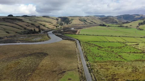 Aerial view of a road winding through patchwork fields in the scenic rural Stock-Footage 256949599