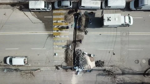 Aerial view of road work. cables are placing to the underground. Stock Footage 148379308