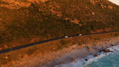 Aerial view of road zigzagging at Chapmans Peak during sunset, South Africa. Stock Footage 120723093