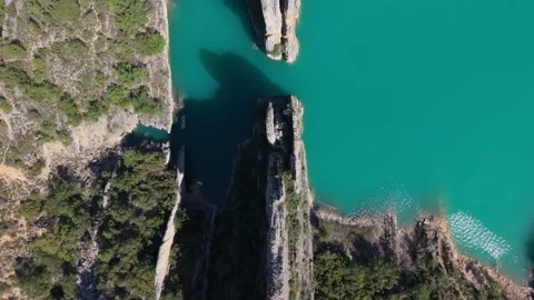 Aerial view of a rock gateway opening to turquoise water Video stock 343325984
