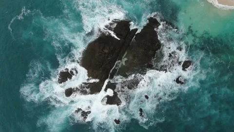 AERIAL VIEW ROCK HIT BY THE WAVES AT BEACH LOMBOK INDONESIA Stock Footage 232509372