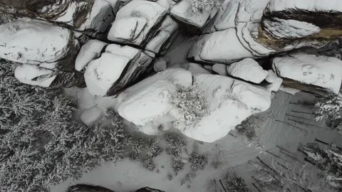 Aerial view of rocks surrounded by forest in winter. Beautiful winter nature Stock Footage 148076128