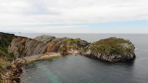 Aerial view of rocky cliffs with beach Stock Footage 114748301