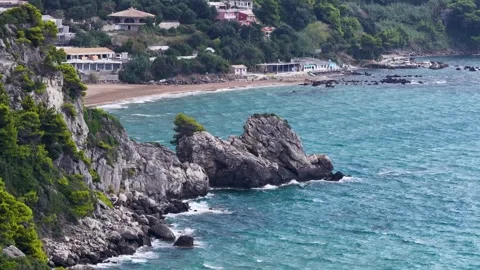 Aerial view of rocky coast and sandy Kontogialos Beach with turquoise water in Stock-Footage 348220249