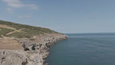 Aerial View of Rocky Coastal Cliffs and Calm Sea Landscape at Daylight Stock Footage 342769475