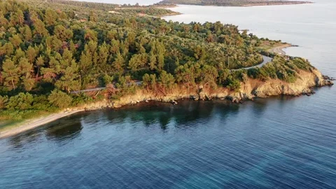 Aerial view of rocky coastline and sea during golden hour. Stock Footage 133388853