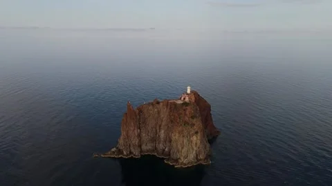 Aerial view of rocky islet with lighthouse in Lipari, Italy. Stock Footage 345667367