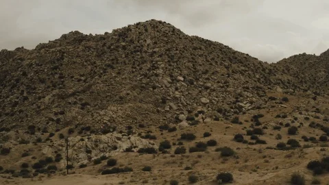Aerial View of rocky mountain with large boulders in the desert Stock Footage 95944584