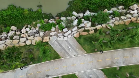 Aerial View of Rocky Pathway Surrounded by Lush Greenery and Decorative Stone Ga Stock Footage 278267772
