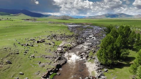 Aerial view of rocky river winding across Mongolian steppe grassland - Prairie Stock Footage 339470696