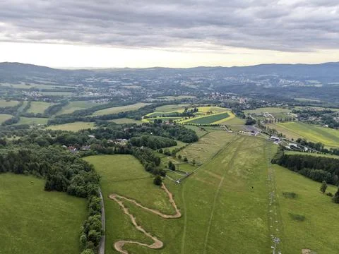 Aerial view of rolling countryside with fields and forest under cloudy sky Stock Photos