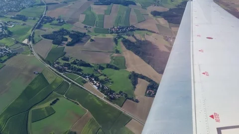 Aerial View of Rolling Fields and Farmlands from Airplane Window Stock Footage 313156340