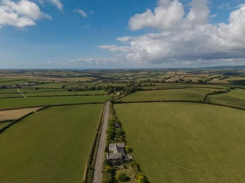 Aerial view of rolling green fields and rural countryside in Lanreath, Cornwall Фото
