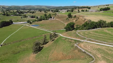 Aerial view of rolling green hills with winding paths. Yorkshire Dales,  Ri.. Stock Footage 346285827