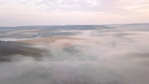 Aerial view of rolling landscape in a soft early morning light. Stock Footage 95003789