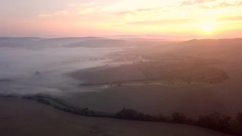 Aerial view of rolling landscape in a soft early morning light. Stock Footage 95004237