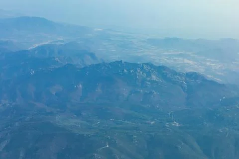 Aerial view of rolling mountain ranges stretching into distance Fotos Stock