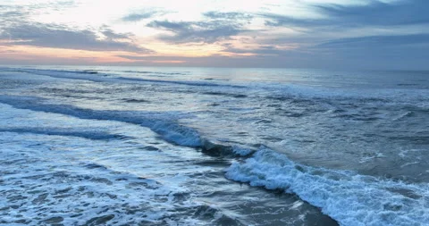 Aerial view of rolling ocean waves at sunset in Portugal. Drone flying over the Stock Footage 221447352