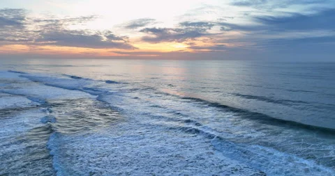 Aerial view of rolling ocean waves at sunset in Portugal. Drone flying over the Stock Footage 221782800