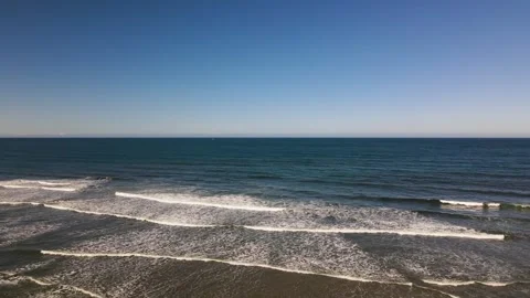 Aerial view of rolling waves along the seashore Stock Footage 241678304