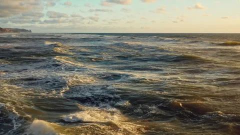 Aerial  View of rolling waves to the shore during sunset. Drone is flying o.. Stock Footage 262436706