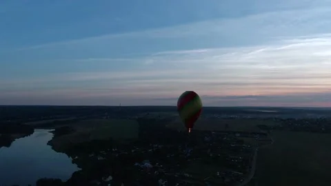 Aerial view romantic balloon flight in the form of a large red heart at sunset. Stock Footage 137975465