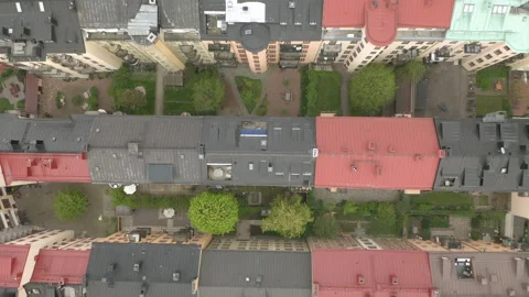 Aerial view of rooftops &amp; empty courtyard during Coronavirus Covid-19 pandemic Stock Footage 133280849