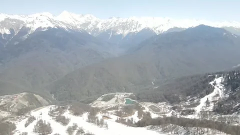 Aerial view of Rosa Khutor resort and mountain peaks Stock Footage 337545447